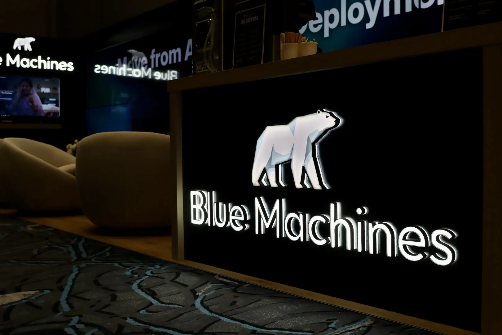Illuminated backlit lightbox logo on the Blue Machines reception counter