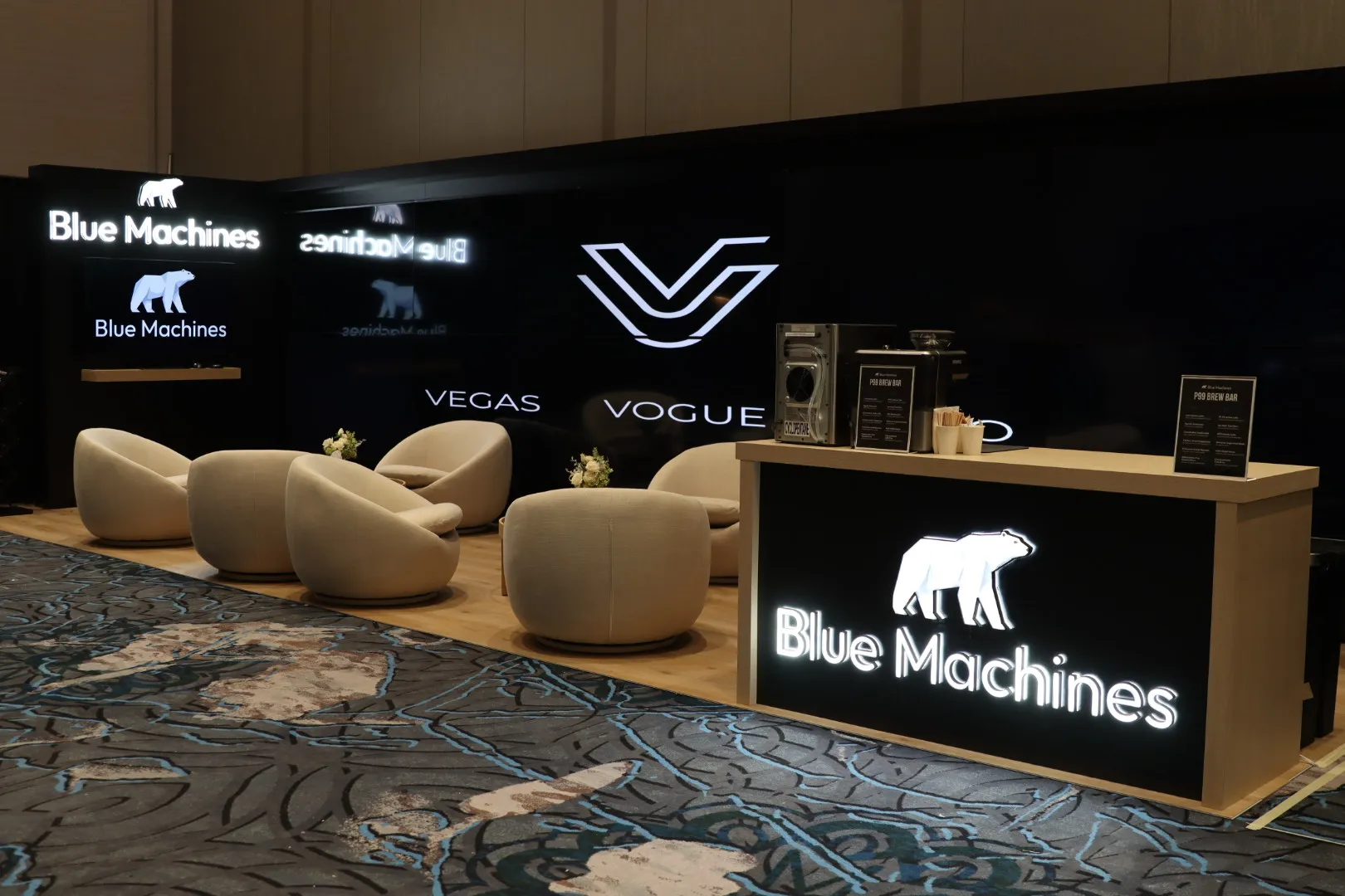 Finished Blue Machines booth built to match its approved 3D rendering, with the video wall live at Caesars Forum