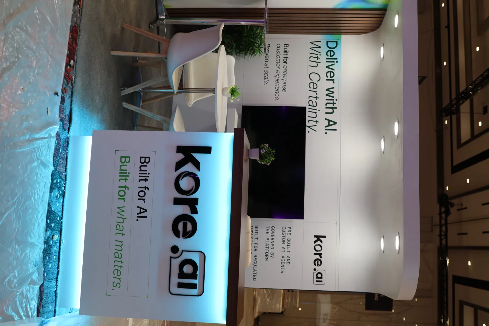 Reconfigurable kore.ai inline booth viewed from the aisle, built from a reusable modular system