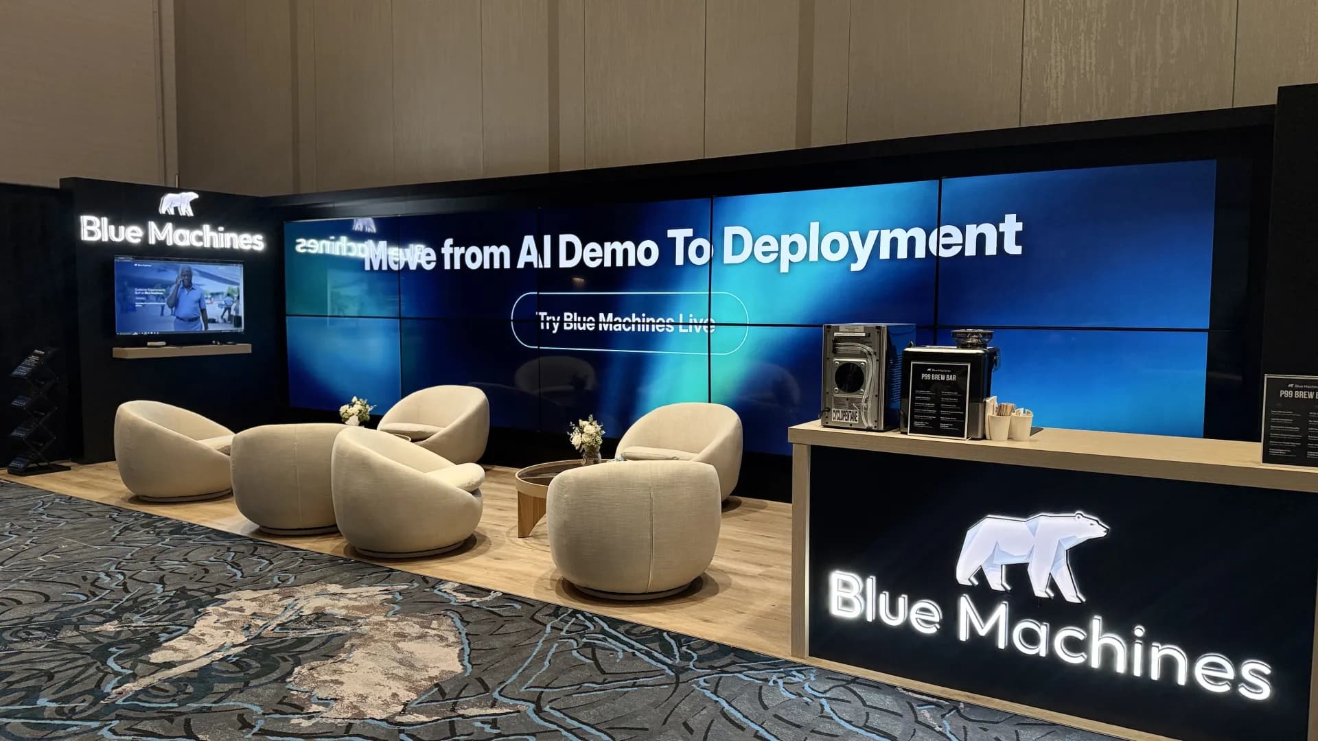 Inviting trade show booth lounge with LED video wall, ready to welcome visitors at Caesars Forum