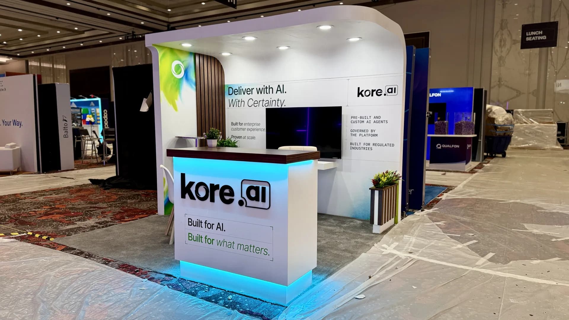 Custom inline booth for kore.ai with a curved archway header on the Caesars Forum show floor